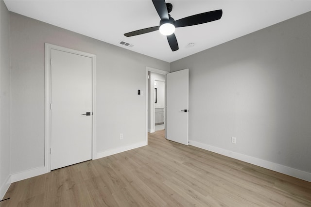 unfurnished bedroom featuring ceiling fan, light hardwood / wood-style floors, and a closet