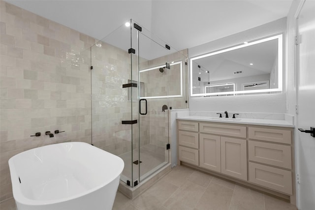 bathroom with plus walk in shower, vanity, tile patterned floors, and vaulted ceiling