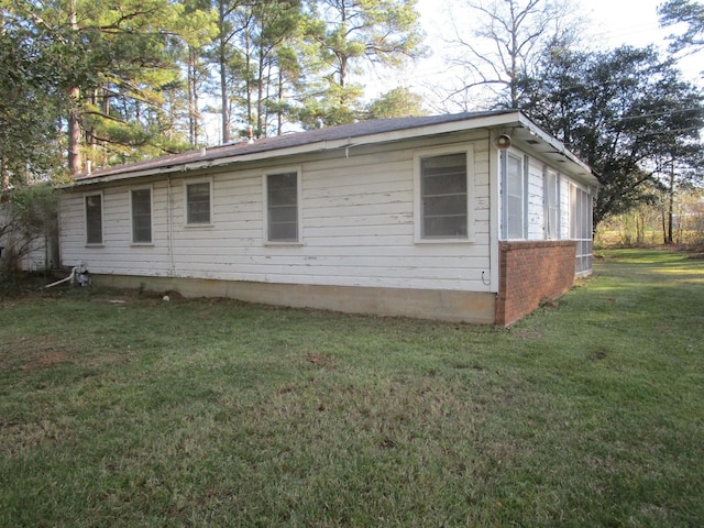 view of home's exterior with a yard