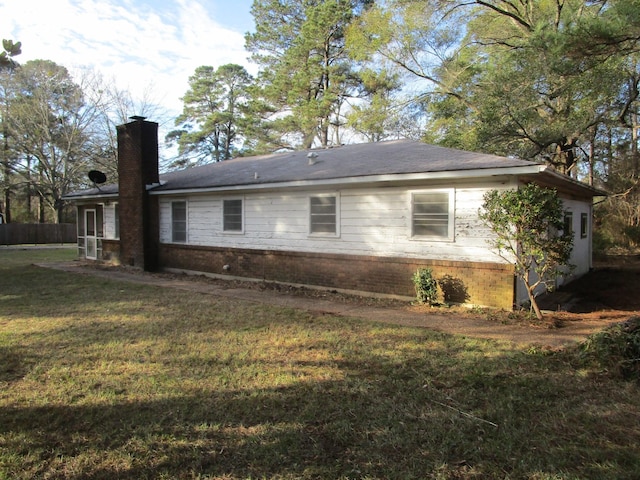 view of side of home featuring a yard