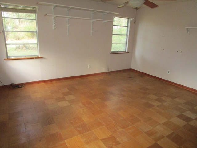 spare room featuring ceiling fan and light parquet flooring