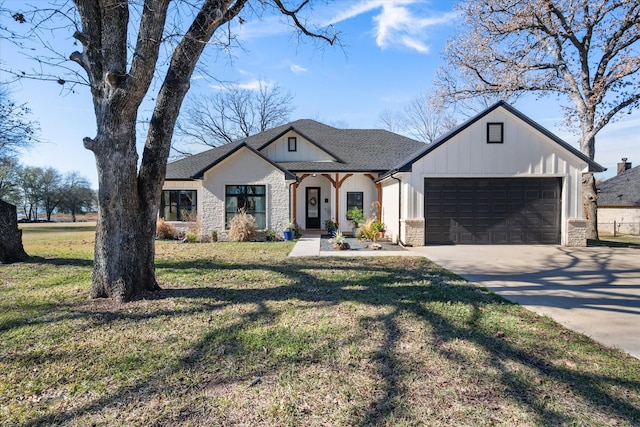 view of front of home with a front lawn and a garage