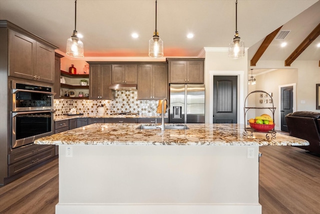 kitchen with tasteful backsplash, visible vents, appliances with stainless steel finishes, a sink, and under cabinet range hood