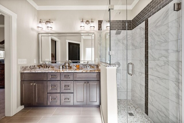 full bathroom featuring ornamental molding, a sink, a shower stall, and double vanity