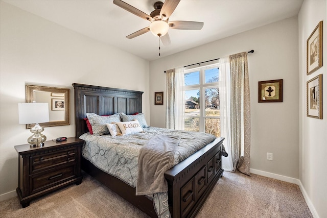 bedroom with light carpet, ceiling fan, and baseboards