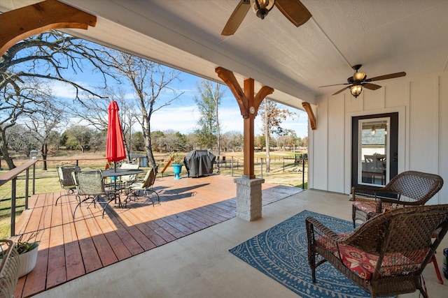 view of patio featuring a ceiling fan, outdoor dining space, and a grill