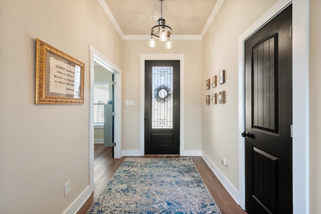 foyer with dark wood-style floors, baseboards, and crown molding