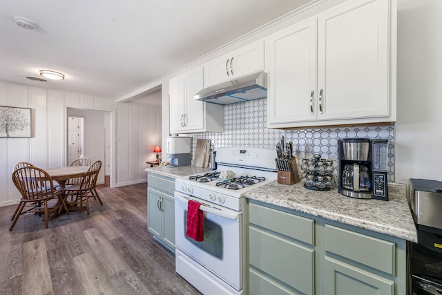 kitchen featuring dark hardwood / wood-style flooring, decorative backsplash, white gas range oven, and white cabinets