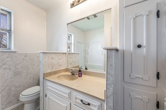 bathroom with walk in shower, toilet, tile walls, a textured ceiling, and vanity