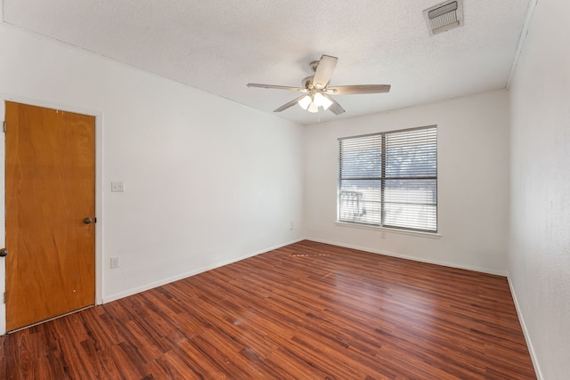 unfurnished room featuring ceiling fan, dark hardwood / wood-style floors, and a textured ceiling