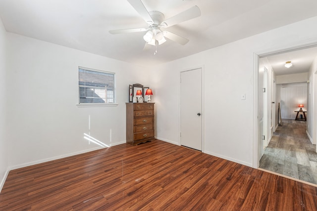 unfurnished bedroom featuring dark hardwood / wood-style floors and ceiling fan