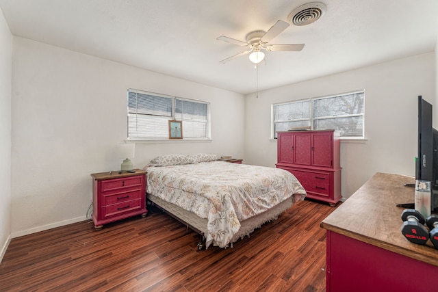 bedroom with dark hardwood / wood-style flooring and ceiling fan