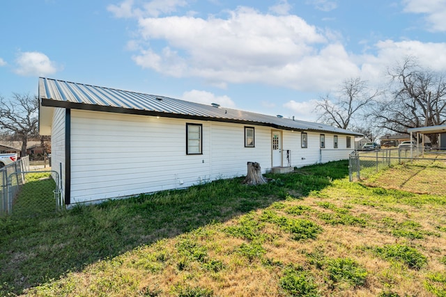 rear view of house featuring a yard