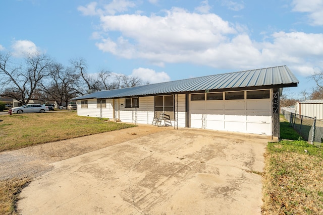 ranch-style home with a garage and a front lawn