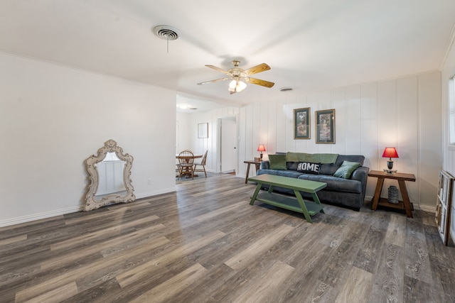 living room featuring ceiling fan and dark hardwood / wood-style flooring