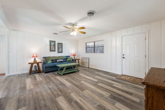 living room with ceiling fan and wood-type flooring