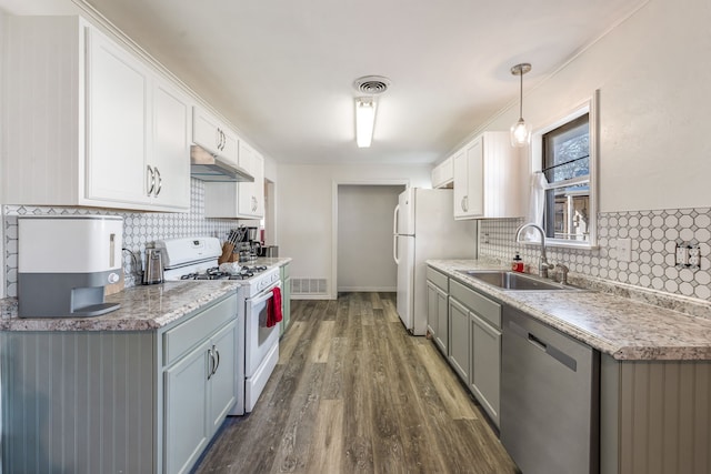 kitchen featuring dark wood-type flooring, sink, white cabinetry, pendant lighting, and white appliances