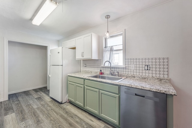 kitchen with pendant lighting, sink, white cabinetry, decorative backsplash, and stainless steel dishwasher