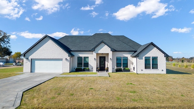 view of front of house featuring a garage and a front lawn