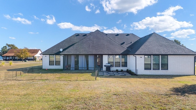 back of house with a yard and a patio area