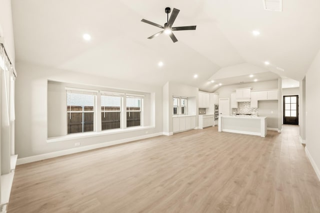 unfurnished living room with lofted ceiling, a ceiling fan, baseboards, visible vents, and light wood-style floors