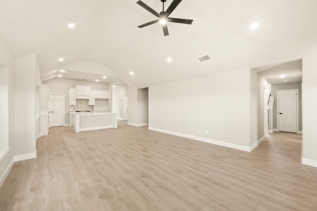 unfurnished living room featuring visible vents, baseboards, ceiling fan, vaulted ceiling, and light wood-style floors