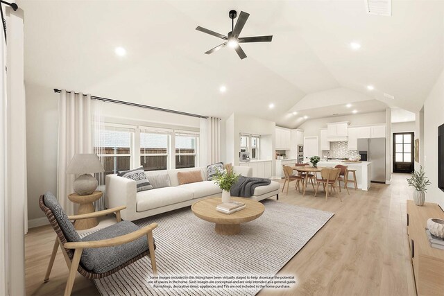 living room featuring light hardwood / wood-style flooring, ceiling fan, and lofted ceiling