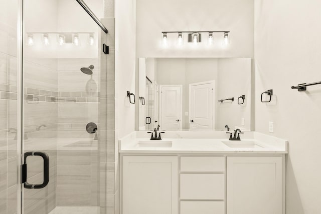 full bathroom featuring a stall shower, a sink, and double vanity