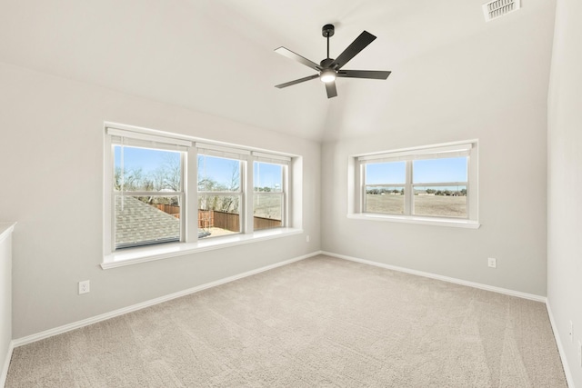 empty room with baseboards, visible vents, a ceiling fan, lofted ceiling, and carpet flooring