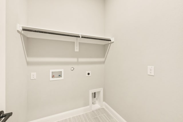 laundry area with washer hookup, hookup for a gas dryer, hookup for an electric dryer, laundry area, and baseboards