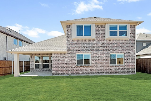 rear view of property featuring a patio area, a fenced backyard, a lawn, and brick siding