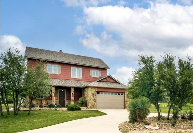 craftsman house featuring a garage and a front lawn