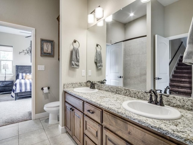 bathroom featuring tile patterned floors, vanity, and toilet