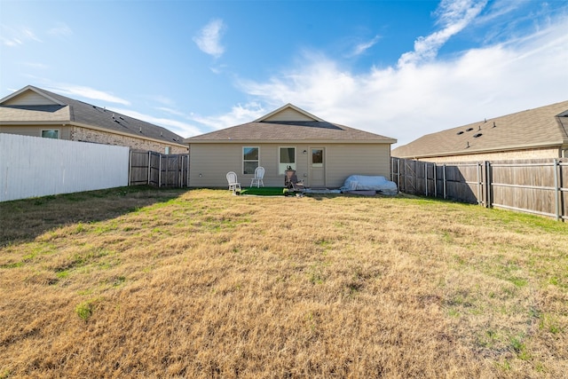 back of house with a lawn