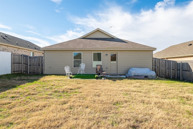 rear view of property with a yard