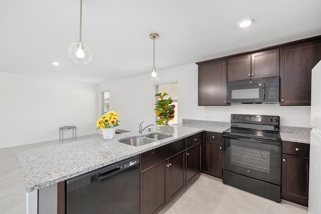 kitchen with dark brown cabinetry, sink, kitchen peninsula, decorative light fixtures, and black appliances