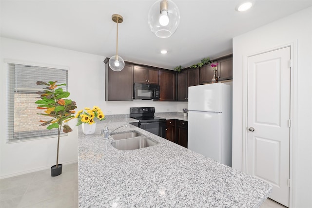 kitchen featuring black appliances, kitchen peninsula, sink, decorative light fixtures, and dark brown cabinets