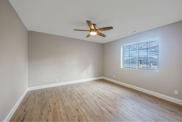 spare room with ceiling fan and light wood-type flooring