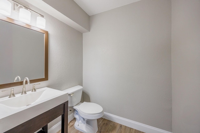 bathroom featuring hardwood / wood-style floors, vanity, and toilet