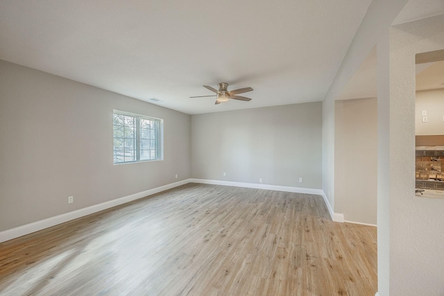 spare room featuring ceiling fan and light hardwood / wood-style flooring