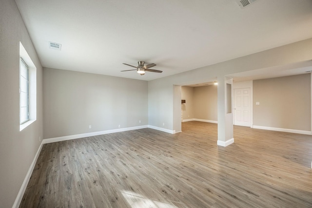 unfurnished room with light wood-type flooring and ceiling fan