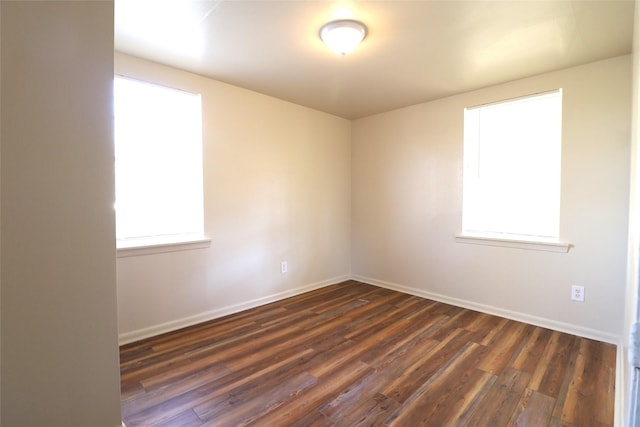 empty room with dark hardwood / wood-style flooring