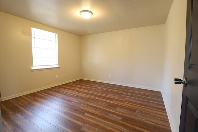 unfurnished room featuring dark wood-type flooring