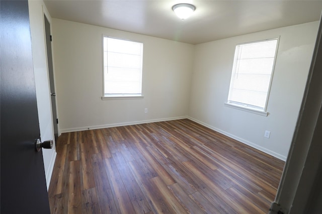 unfurnished room featuring dark wood-type flooring