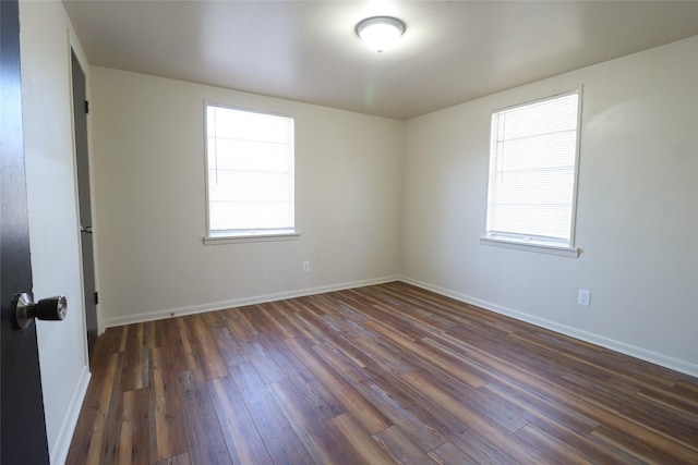 empty room featuring dark wood-type flooring