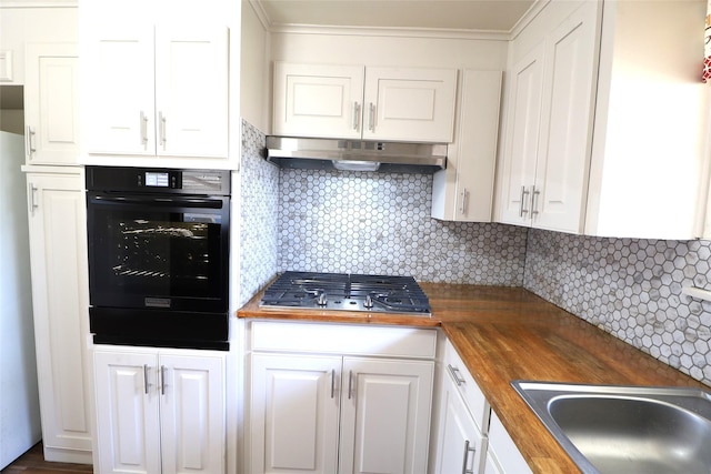 kitchen featuring tasteful backsplash, stainless steel gas cooktop, white cabinets, butcher block countertops, and oven