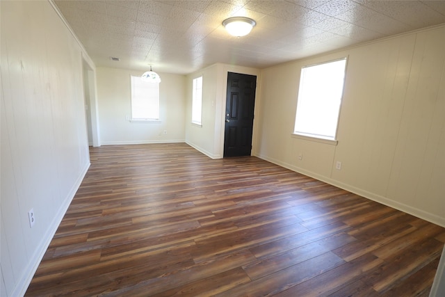 unfurnished room featuring dark wood-type flooring