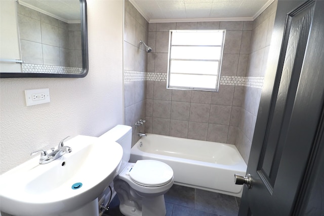 full bathroom with toilet, sink, ornamental molding, and tiled shower / bath