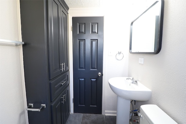 bathroom featuring toilet and tile patterned floors