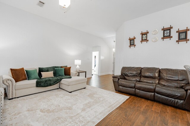 living room featuring hardwood / wood-style flooring and lofted ceiling